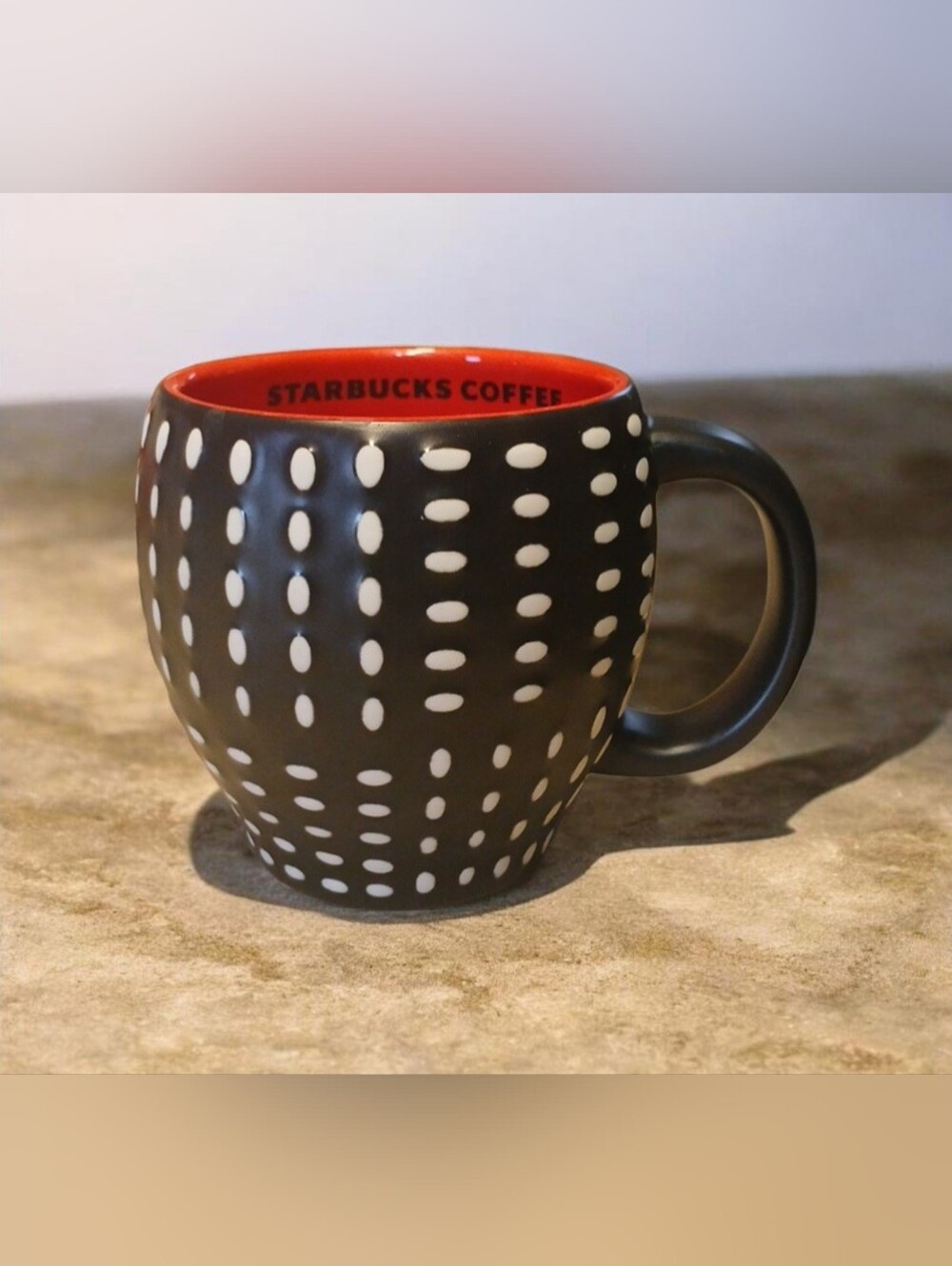 Starbucks 2008 Black Ceramic Mug with White Polka Dots and a Red Interior